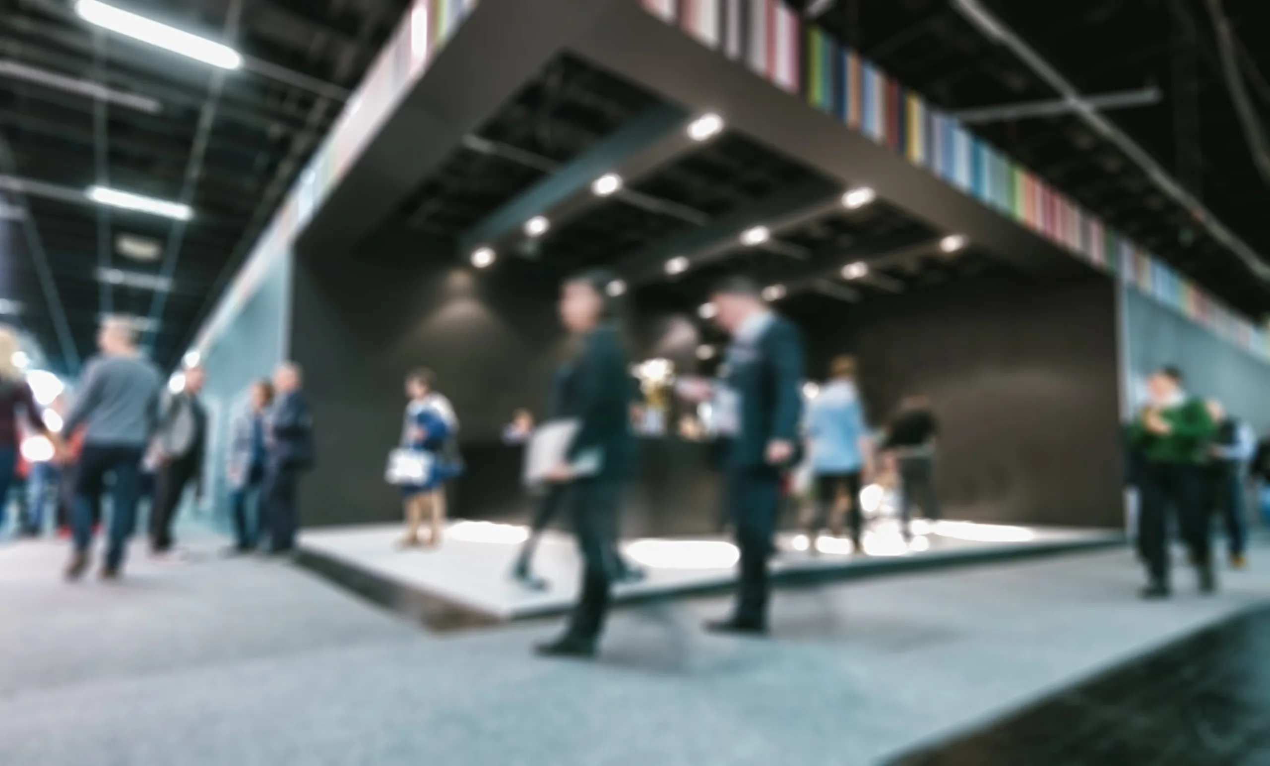 blurred business people standing walking tradeshow booth intentionally blurred post production ideal websites magazines layouts (1)